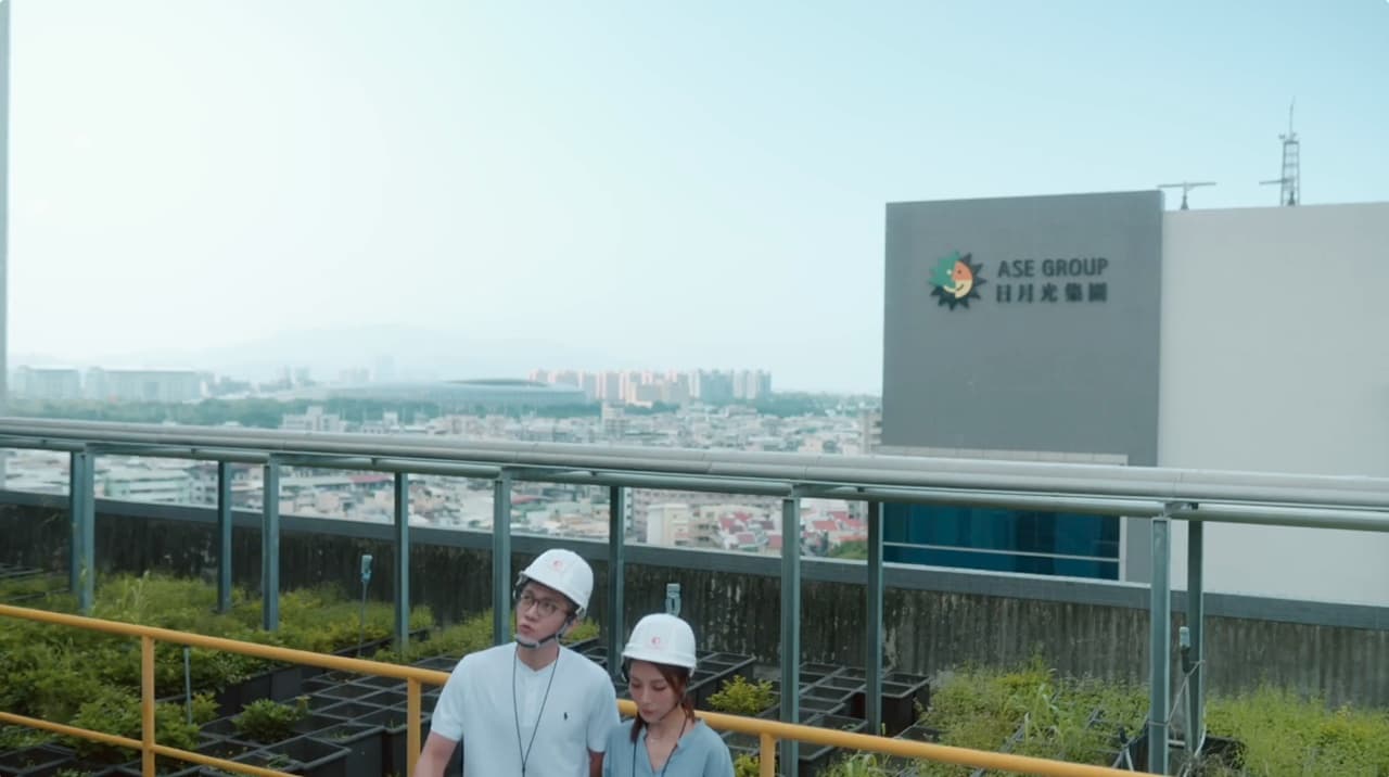 ASE staff in hard hats inspecting a planted green roof above a Kaohsiung facility